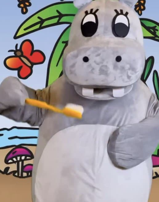 The OTA mascot brushing its teeth in front of the jungle backdrop
